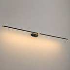 Linear wall sconce with a black horizontal light bar casting warm light across a neutral wall.