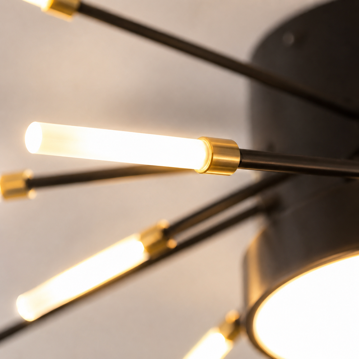 Close-up of a ceiling light showing illuminated LED rods connected to the black center.