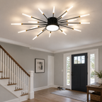 Black starburst ceiling light glowing above a bright entryway with stairs and a glass door.