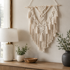 Natural macrame wall hanging with geometric knots above a styled console.