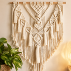 Natural macrame wall hanging with detailed knots beside a leafy plant.