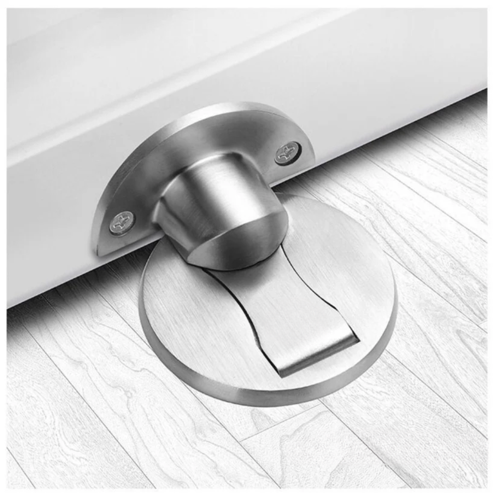 Silver magnetic door stop installed on a pale wood floor.