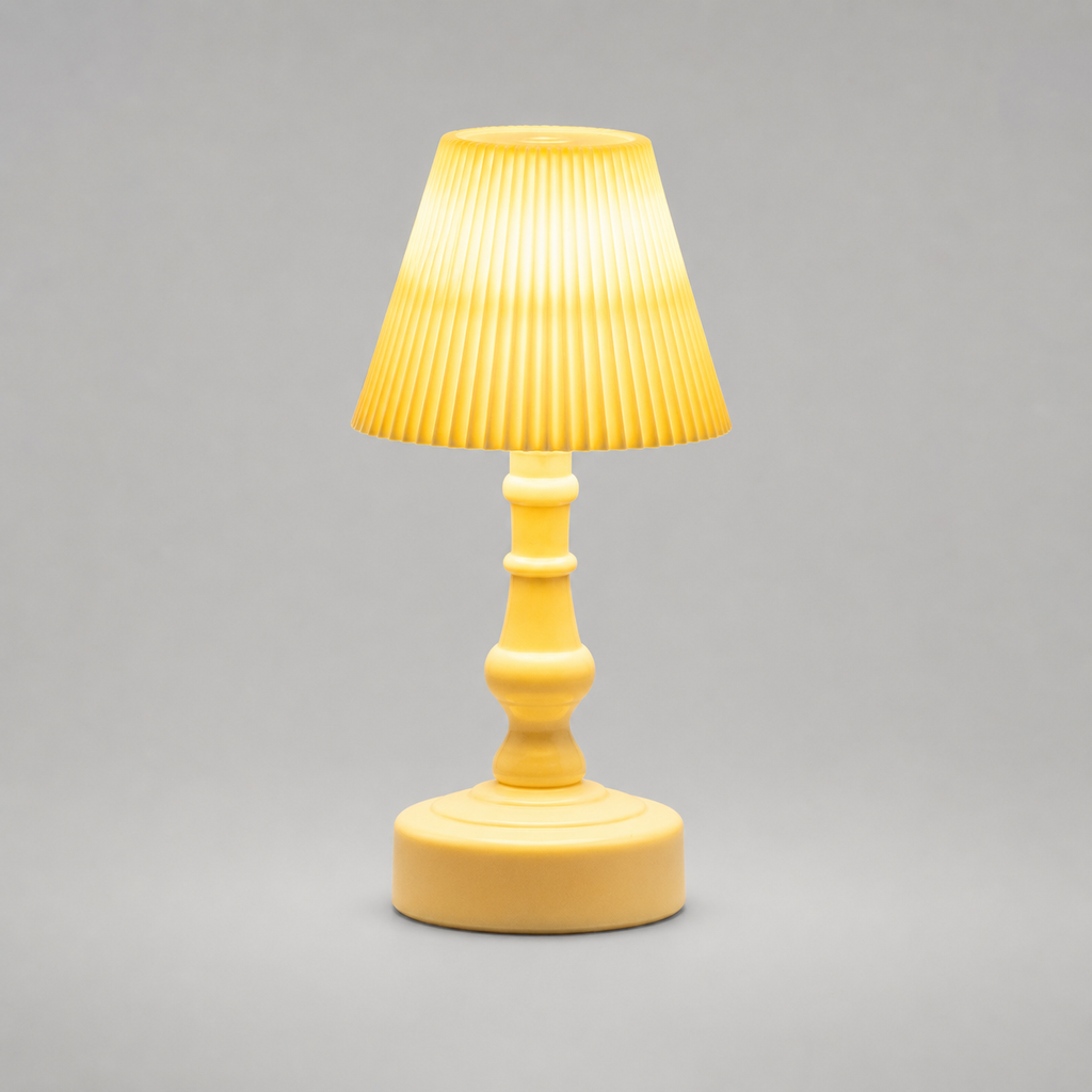 A small yellow table lamp with a pleated fabric shade, a turned wooden-style stem, and a round base, shown against a plain gray studio background.