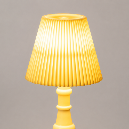 A yellow table lamp with a pleated conical shade and a matching cylindrical base, shown against a plain gray background.