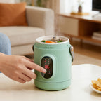 Green mini cooking pot with front controls in use