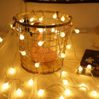 Warm white mini globe fairy lights around a decorative basket