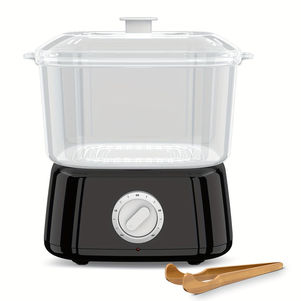 Black mini towel steamer with clear lidded chamber and wooden tongs