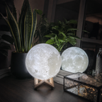 Moon lamp on engineered wood stand in a calm bedroom