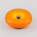 A glossy orange donut-shaped light or lamp with a metallic silver center and a dark base, shown on a light gray background.