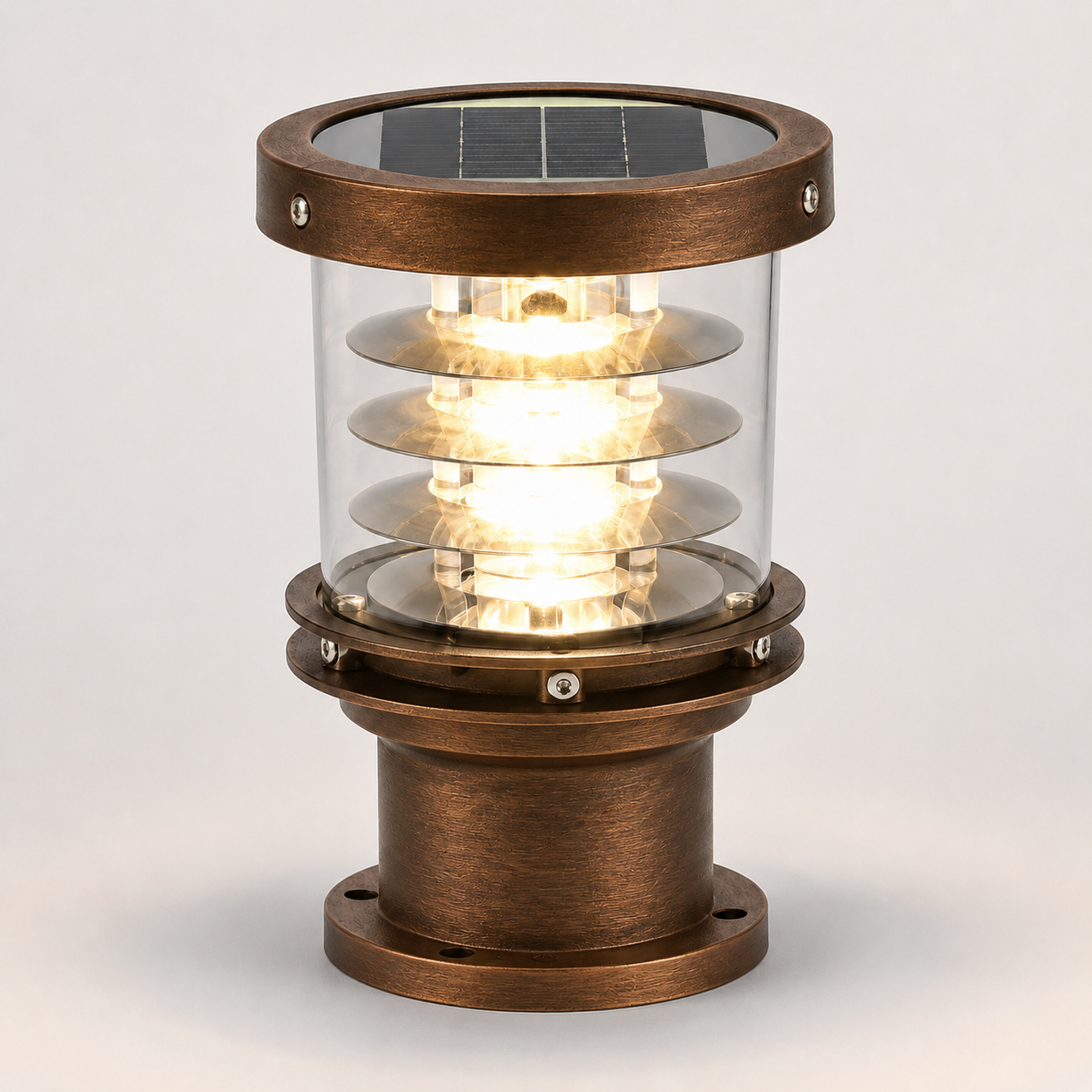 A solar-powered outdoor bollard light with an antique bronze metal finish, clear glass shade, and integrated solar panel on top, shown illuminated against a neutral light gray background.