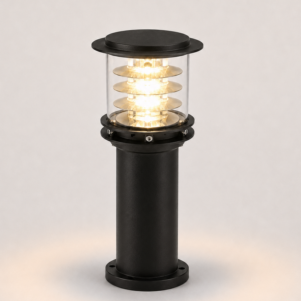 A modern black outdoor bollard light with a clear glass shade showing glowing warm white LED coils, set against a neutral light gray background.