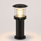 A modern black outdoor bollard light with a clear glass shade showing glowing warm white LED coils, set against a neutral light gray background.