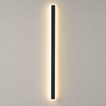 Outdoor wall sconce with a slim black vertical body glowing warm against a light gray wall.