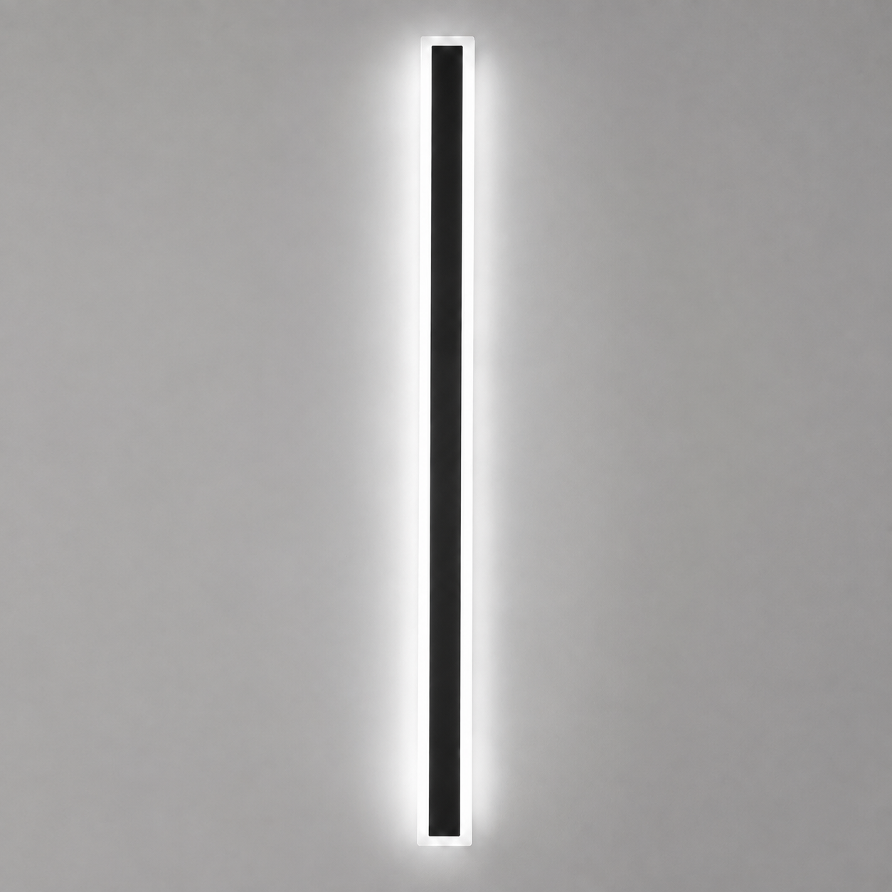 Outdoor wall sconce with a slim black body casting cool white light on a gray wall.