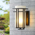 Black outdoor wall sconce mounted on gray exterior masonry.