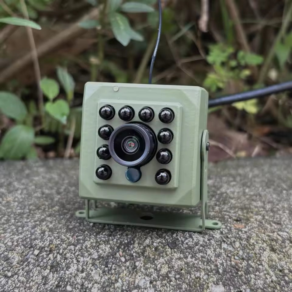 Green outdoor WiFi surveillance camera for bird observation, lifestyle view.