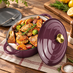 Burgundy oval enameled Dutch oven with lid and prepared meal