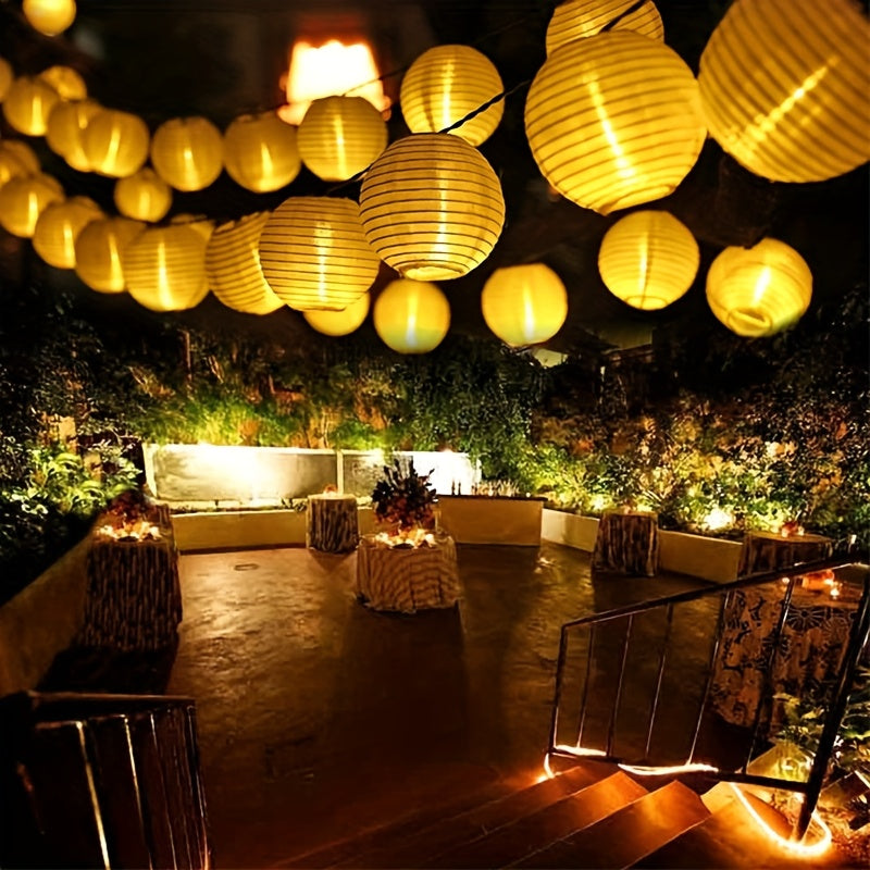 Paper lantern string lights glowing above a decorated dining area.