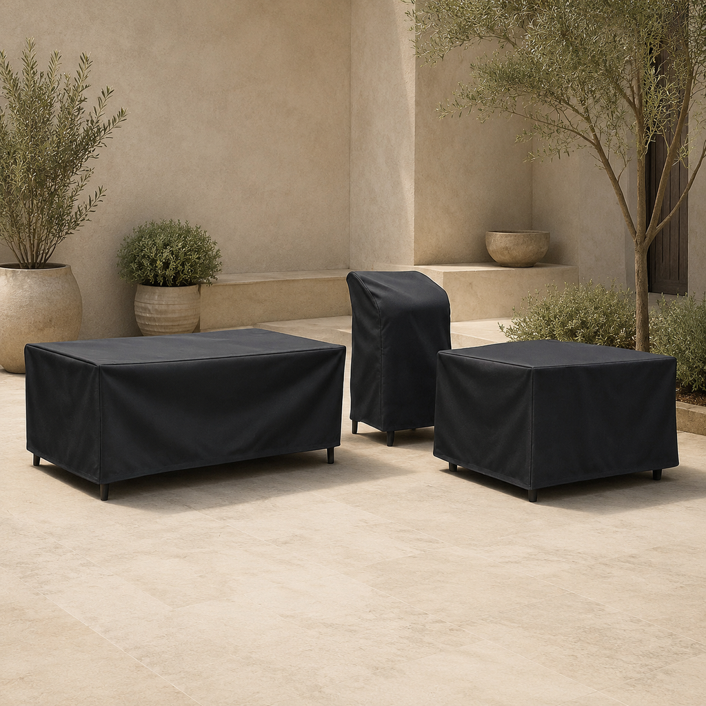 black patio furniture covers protecting a sofa, chairs and ottoman