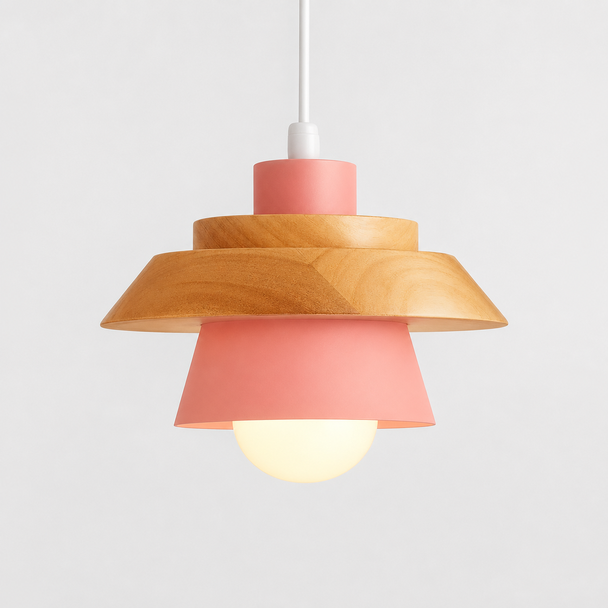 Pink cone pendant light with natural wood accent, glowing against a light gray background.
