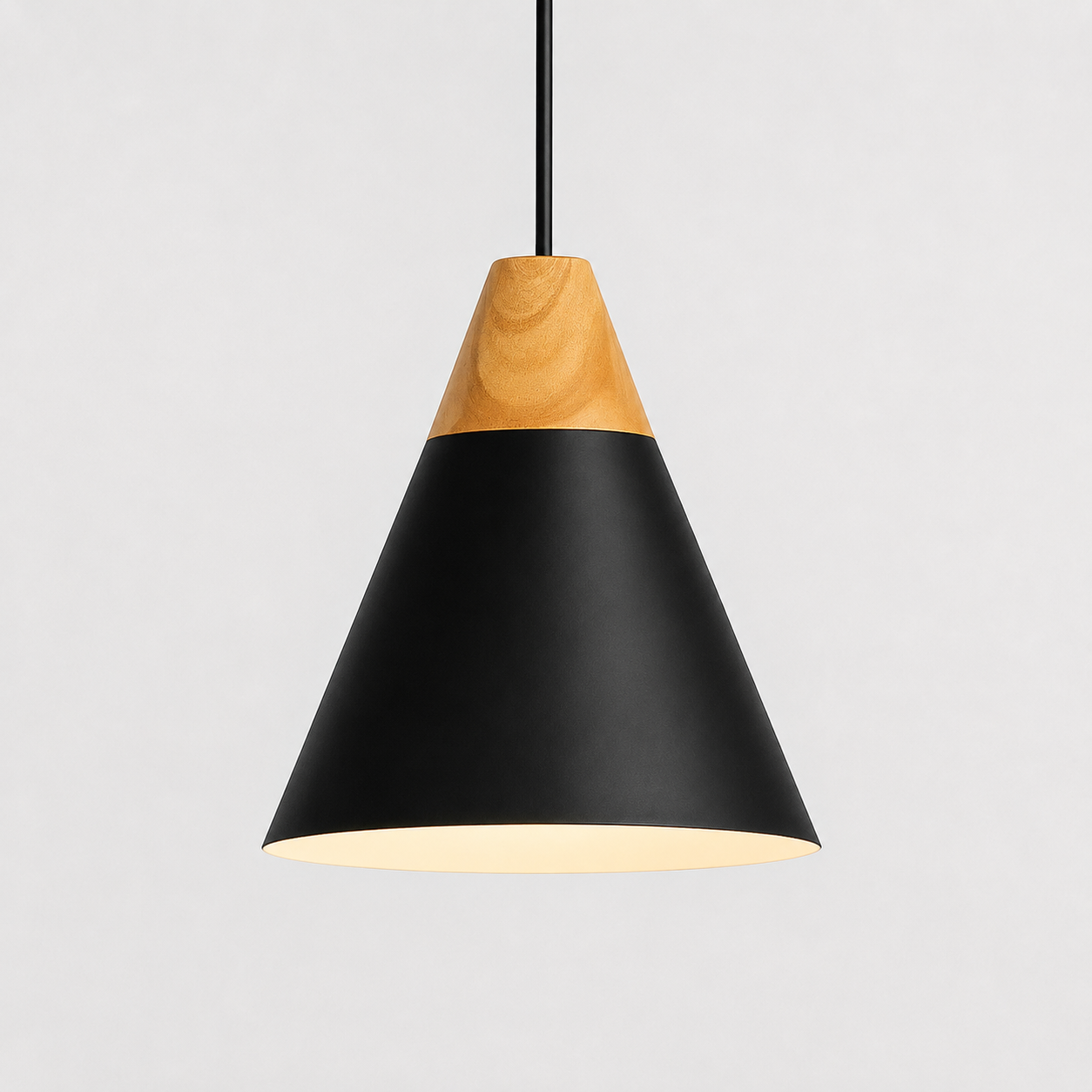 Black cone pendant light with natural wood accent, glowing against a light gray background.