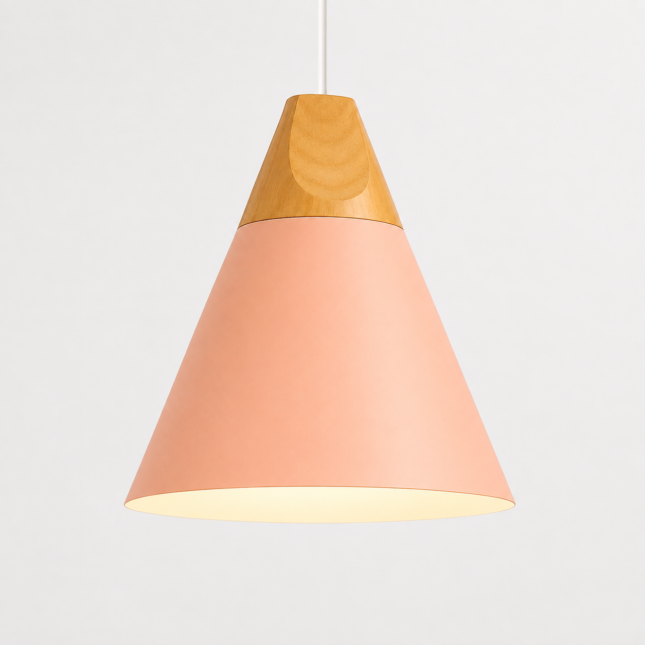 Pink cone pendant light with natural wood accent, glowing against a light gray background.