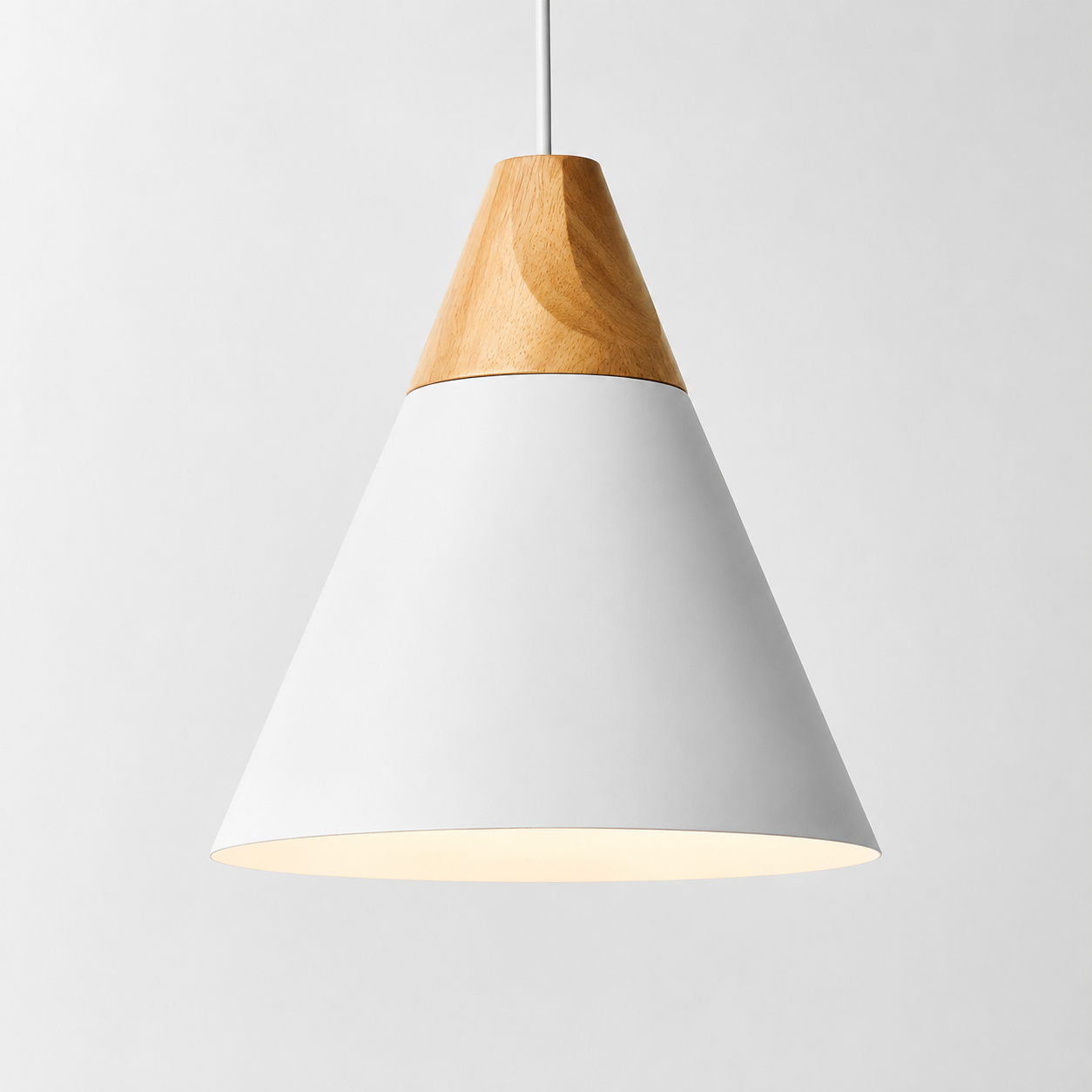 White cone pendant light with natural wood accent, glowing against a light gray background.