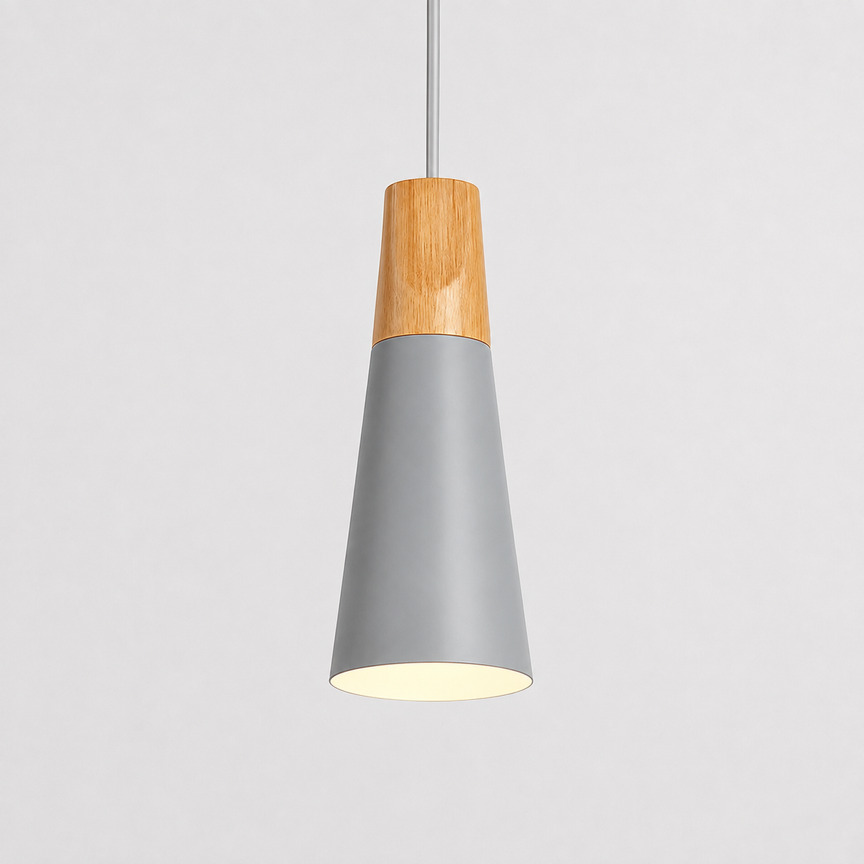 Gray cone pendant light with a natural wood accent, illuminated against a light gray background.