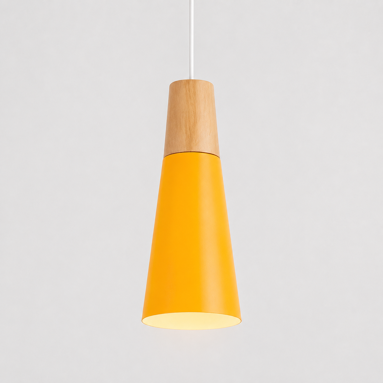 Yellow cone pendant light with natural wood accent, glowing against a light gray background.