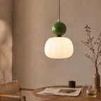 single green Bauhaus pendant light over a dining nook