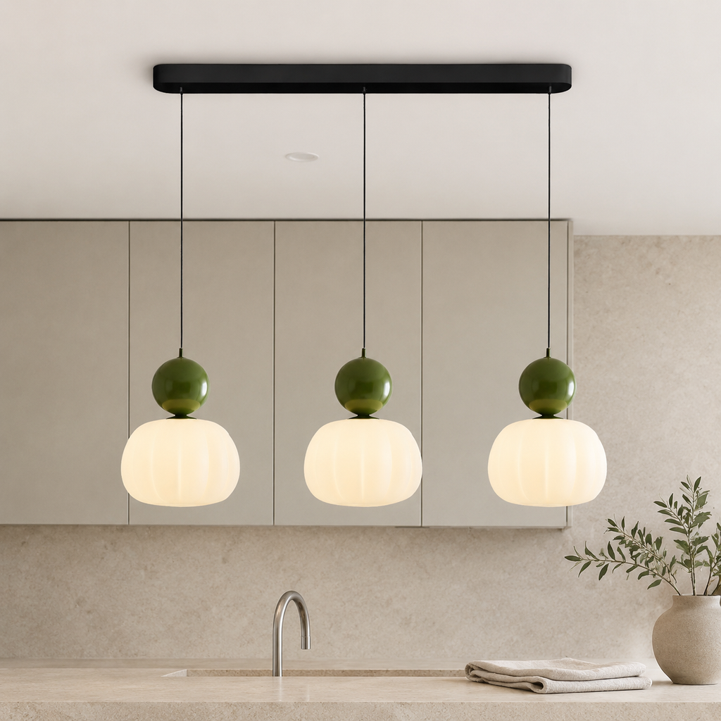 three green Bauhaus pendant light fixtures above a stone counter