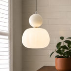 single beige Bauhaus pendant light against white tile