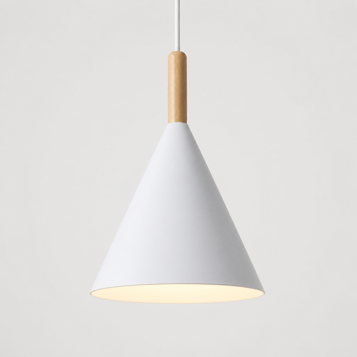 White conical pendant light with a natural wood stem, glowing warm white against a neutral background.
