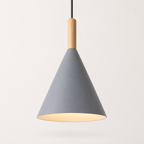 Gray conical pendant light with a natural wood stem, glowing warm white against a neutral background.
