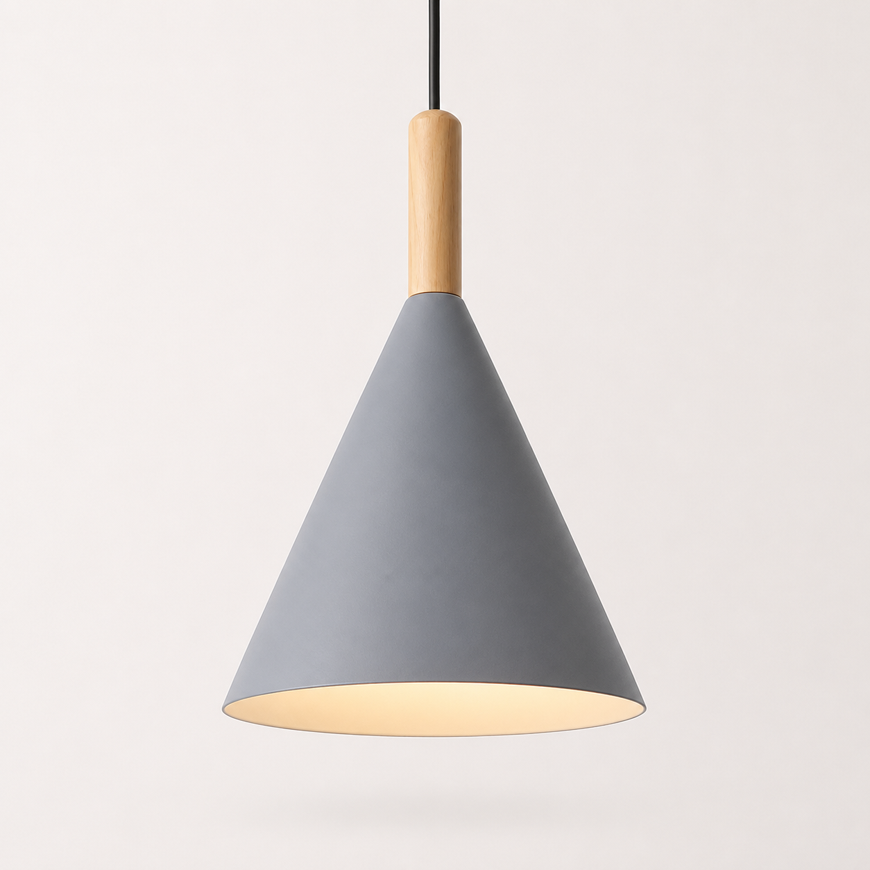 Gray conical pendant light with a natural wood stem, glowing warm white against a neutral background.
