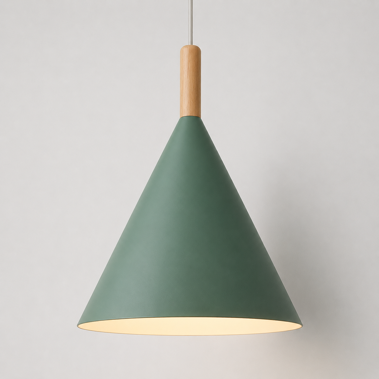 Green conical pendant light with a natural wood stem, glowing warm white against a neutral background.
