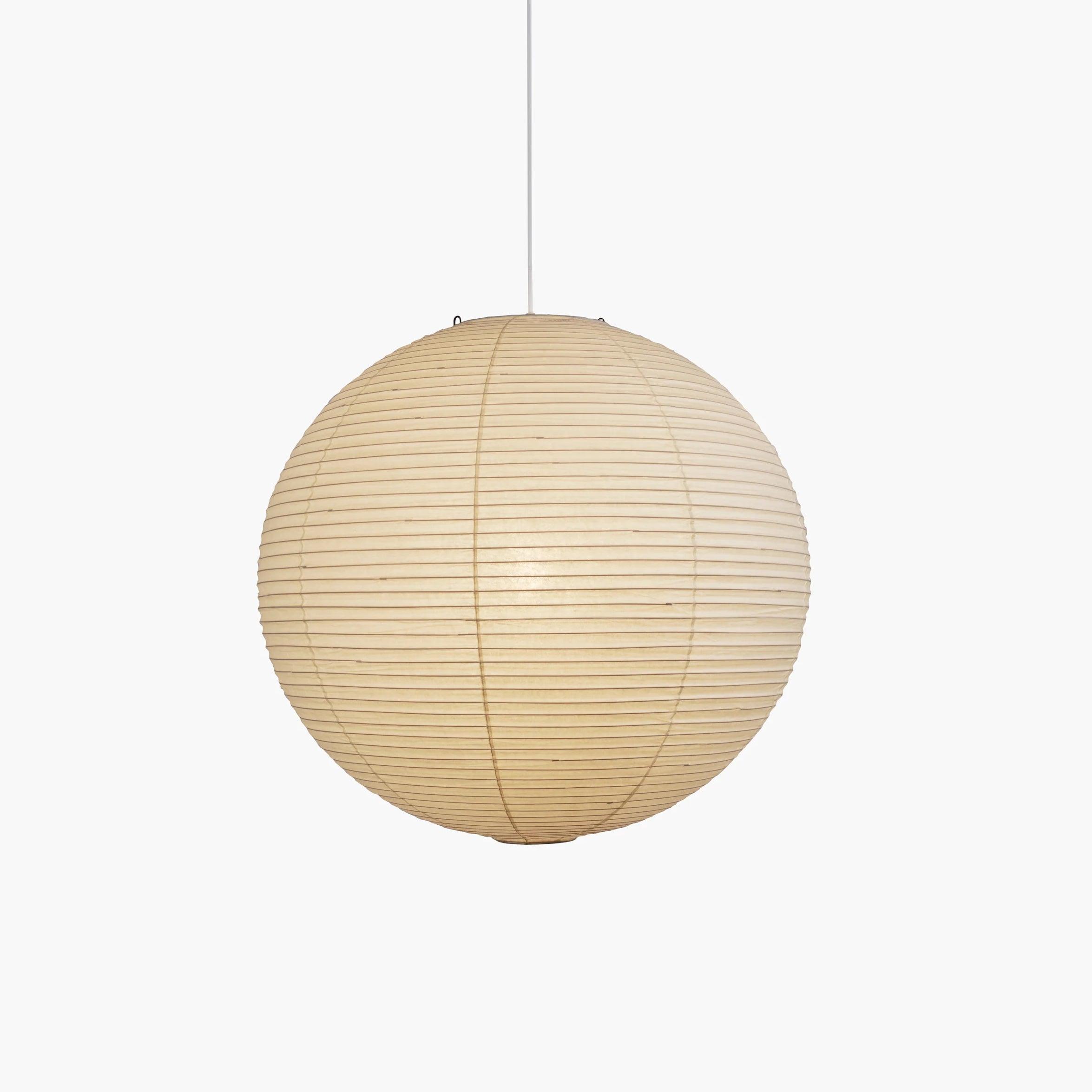 Pendant light with a round ribbed paper shade and white suspension wire
