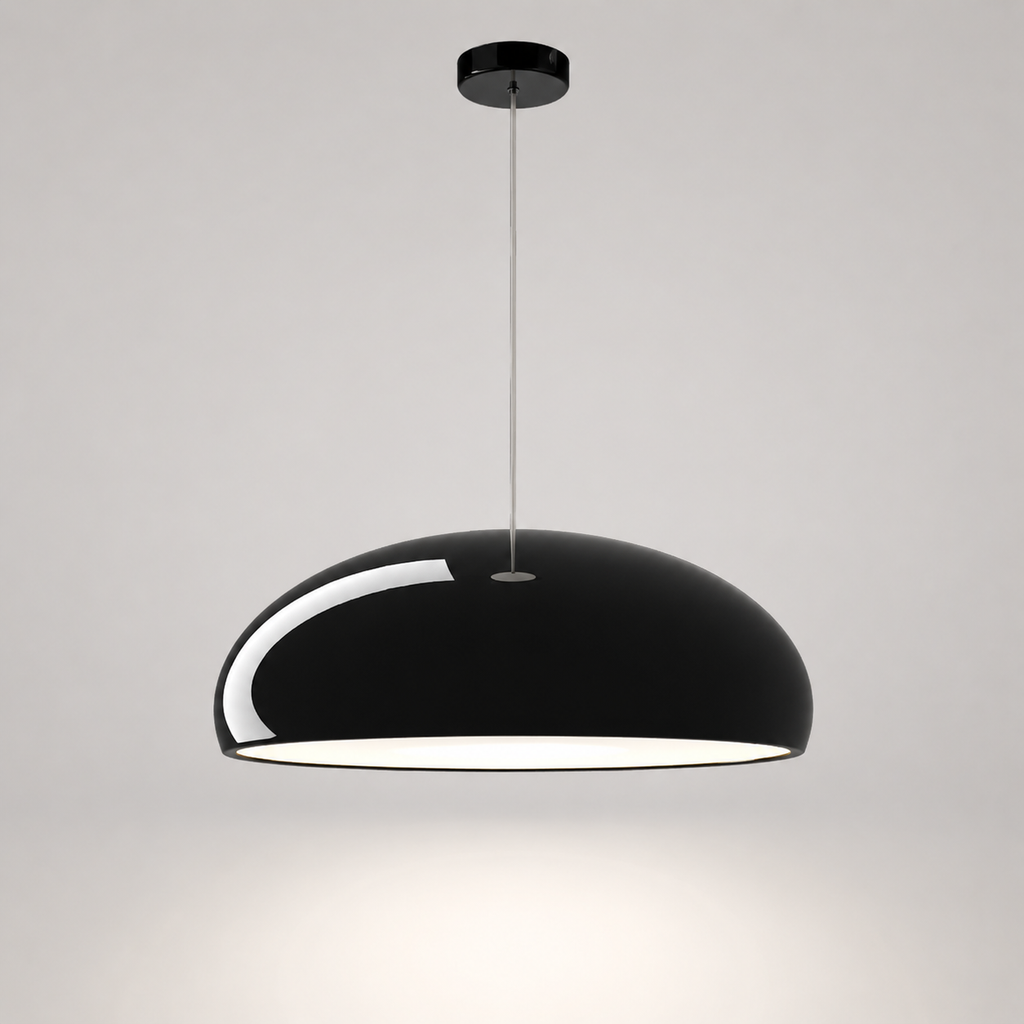 Black dome pendant light with a white inner shade hanging from a thin cord on a neutral background.
