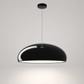 Black dome pendant light with a white inner shade hanging from a thin cord on a neutral background.