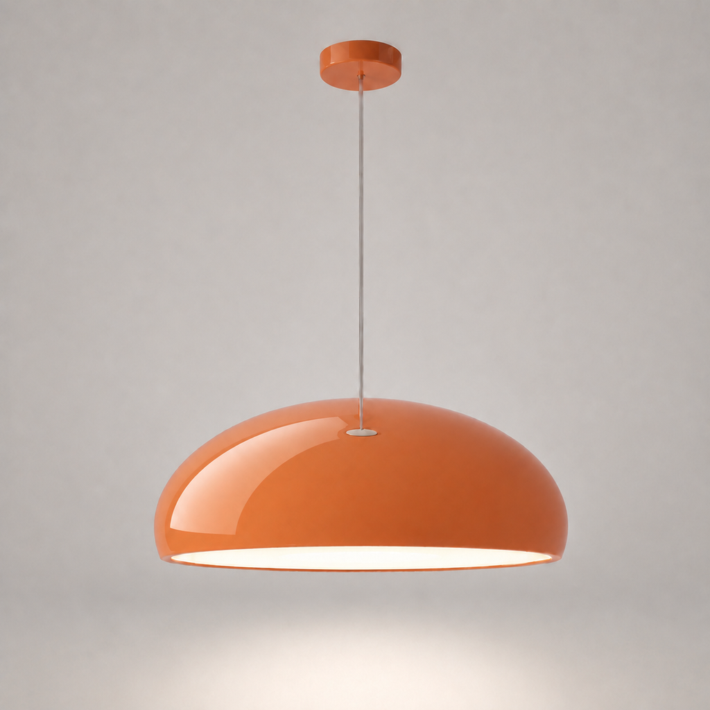 Orange dome pendant light with a glossy finish, matching orange canopy, clear cord, and illuminated underside.