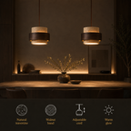 Pendant light hanging above a dining table with feature icons for travertine, walnut band, adjustable cord, and warm glow.