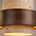 Pendant light close-up showing the textured travertine shade and dark walnut band.