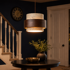 Pendant light hanging in a hallway near a staircase with warm lighting in the evening.