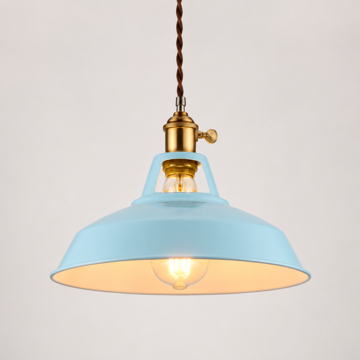 Metal pendant light with a brass socket, twisted brown cord, and exposed warm-glowing bulb.