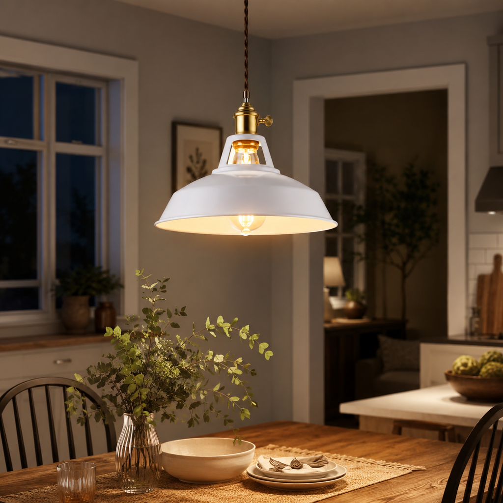 Metal pendant light with a brass socket, twisted brown cord, and exposed warm-glowing bulb.
