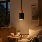 Pendant light glowing above a modern living room seating area with a focused pool of light.