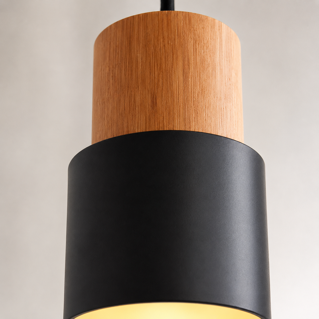 Close-up of pendant light showing the natural wood cylinder and smooth metal shade.