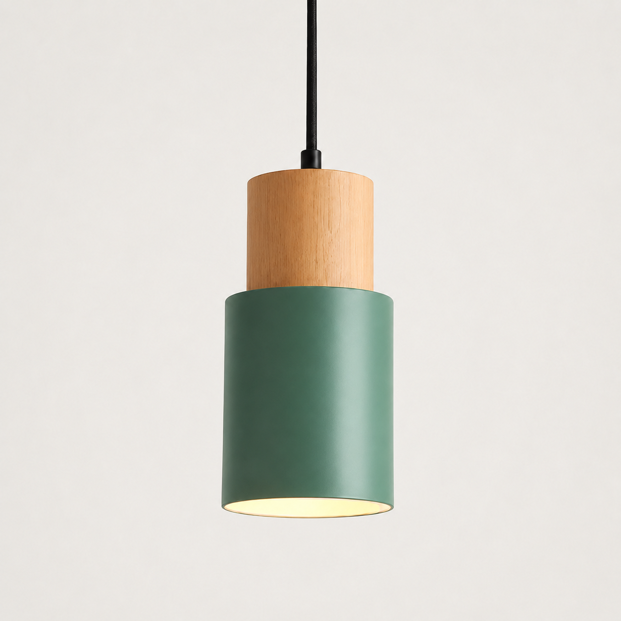 Green pendant light with a cylindrical wood and metal body on a clean white background.