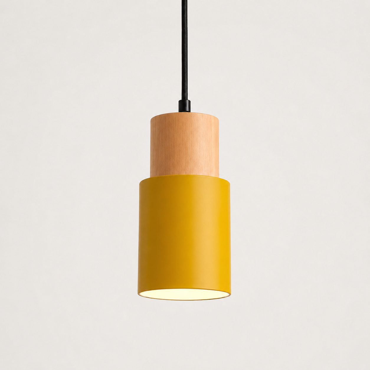 Yellow pendant light with a cylindrical wood and metal body on a clean white background.