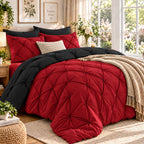 Red comforter with a black reverse on a bed